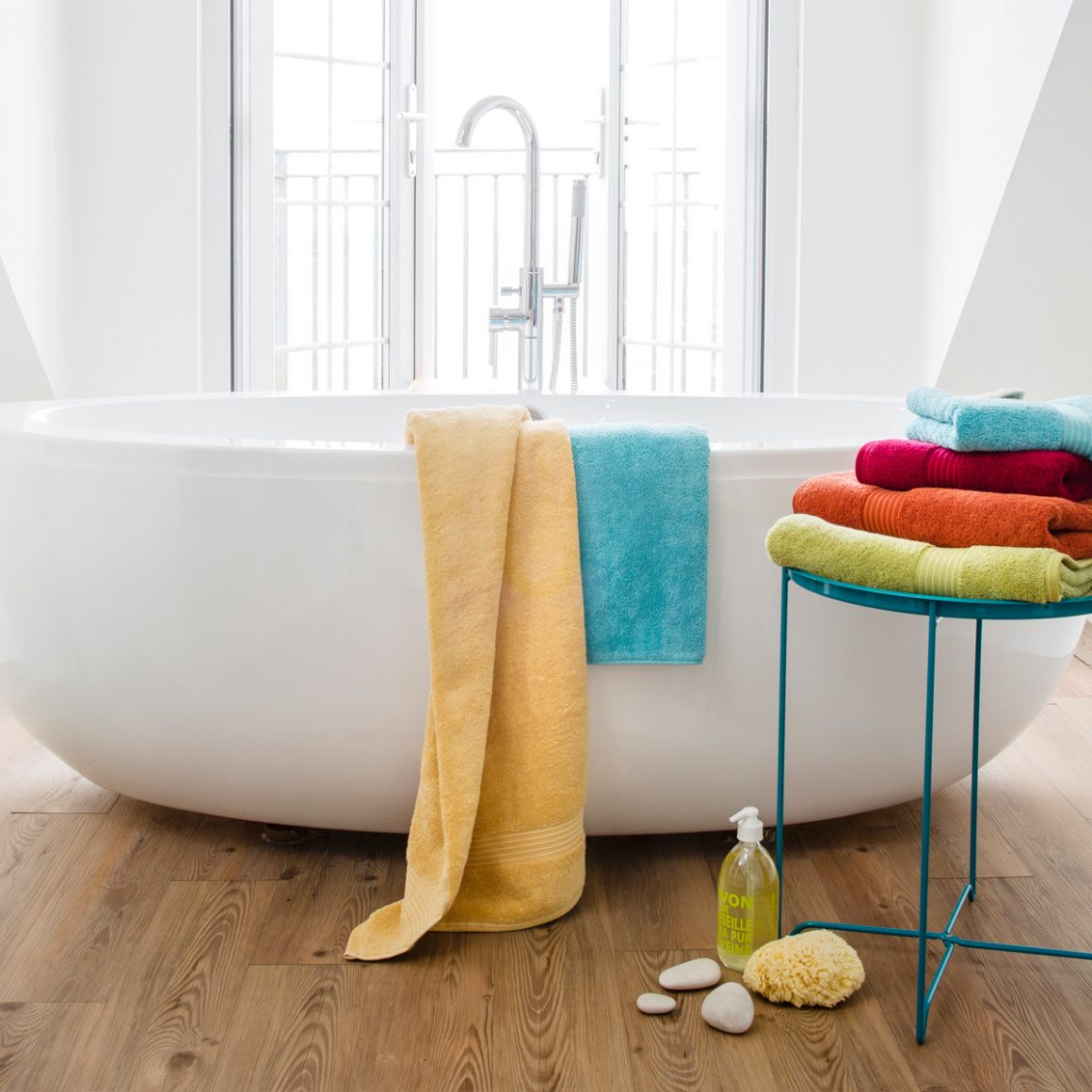 freestanding bath colourful towels